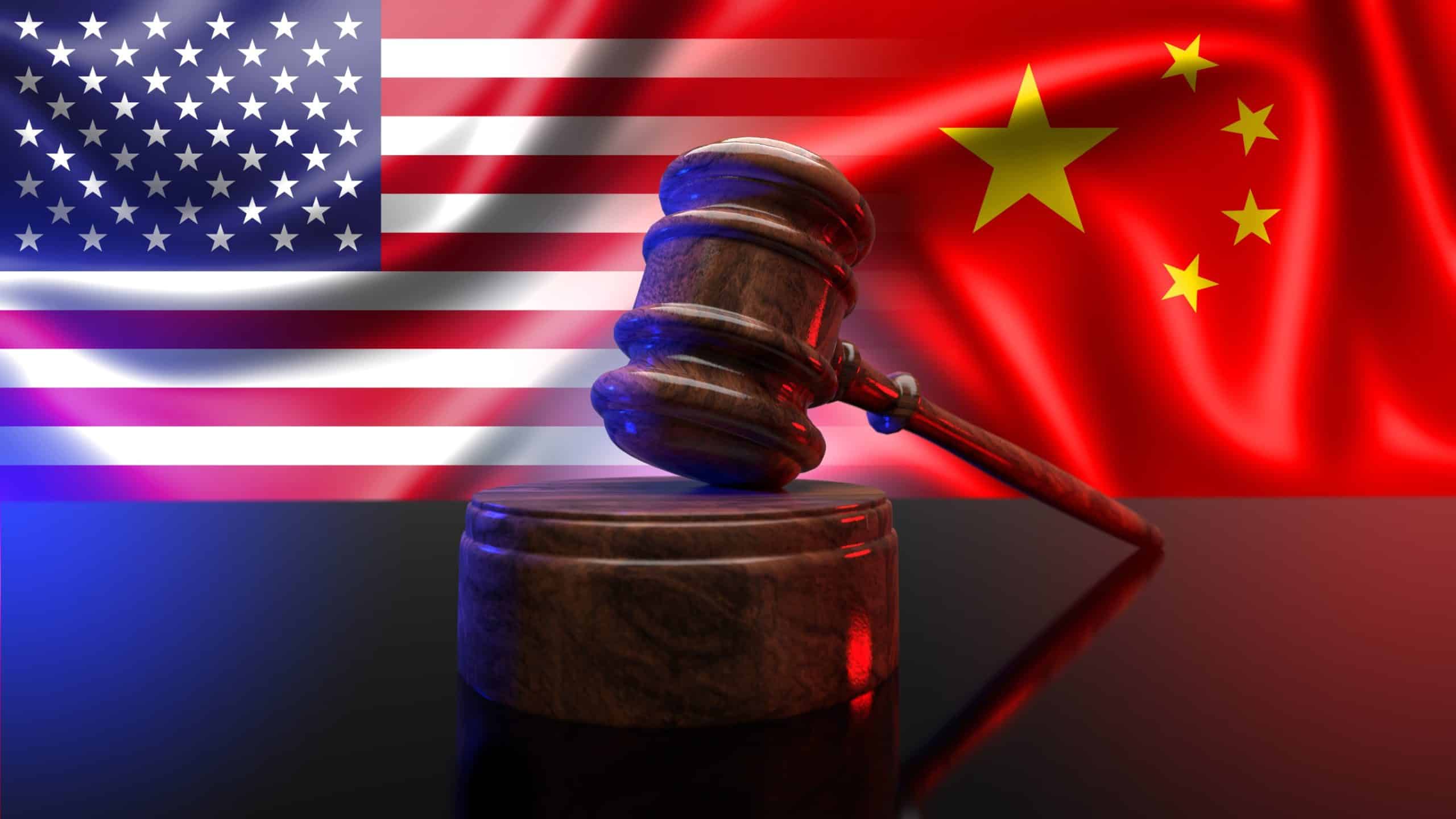 A court gavel on a judge’s bench with a background of the US and China flags
